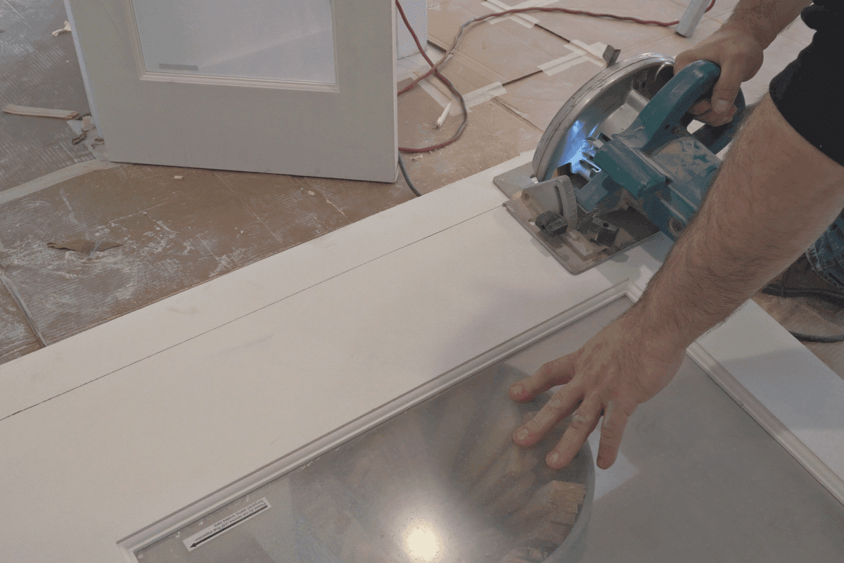 man using a circular saw for cutting wood door construction and home renovation