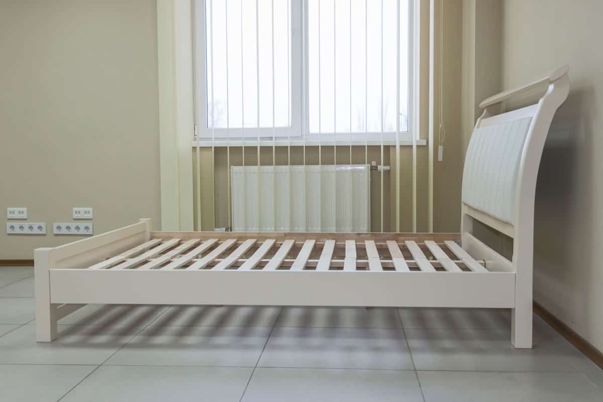 white wooden bed with soft bedhead