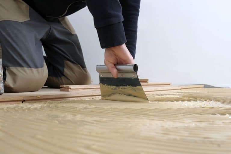 worker-applied-adhesive-parquet-renovation, How To Fix Lifeproof Flooring Seams