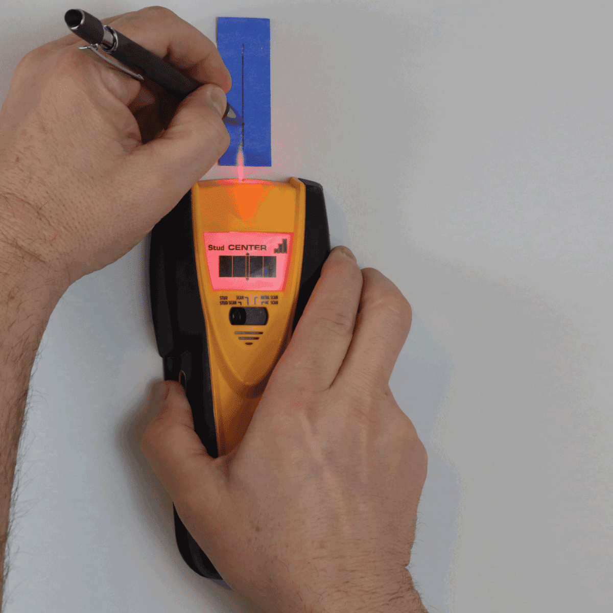 DIY using electronic stud finder to search wall for studs