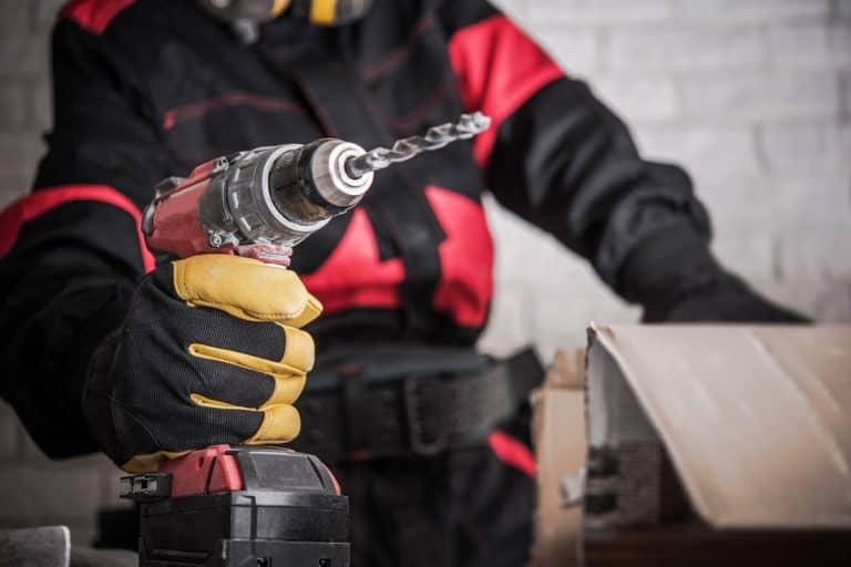 Construction Site Power Drill Tools. Contractor Worker with Powerful Cordless Drill Driver in Hand, My Dewalt Drill Is Smoking - Why? What To Do?