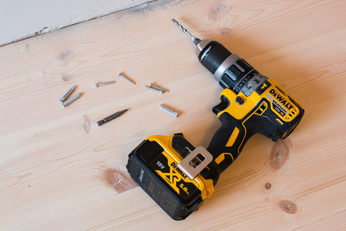 Drilling a hole in a concrete wall using a cordless Dewalt drill