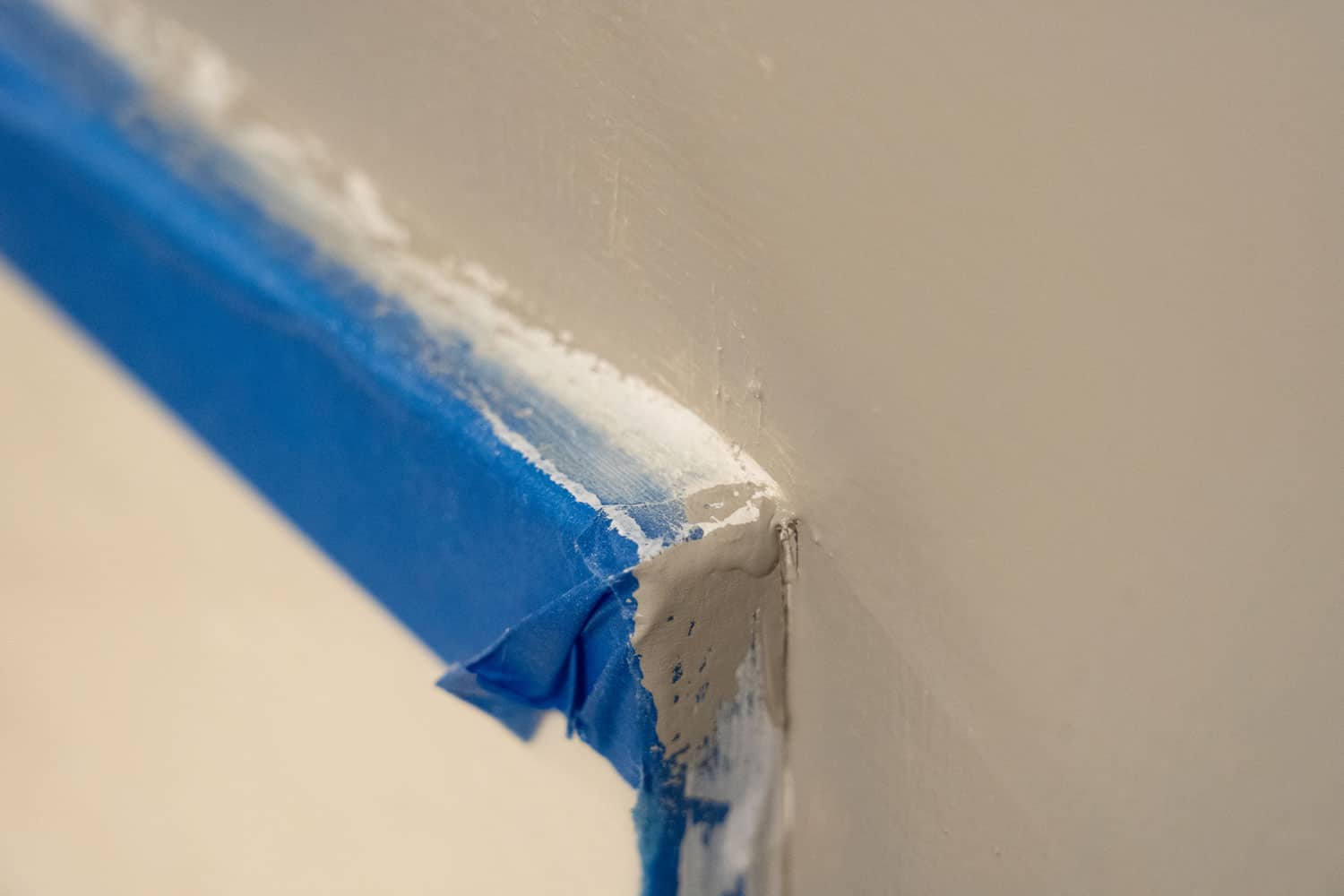 Painter's tape is used along edges while painting to protect surfaces. 