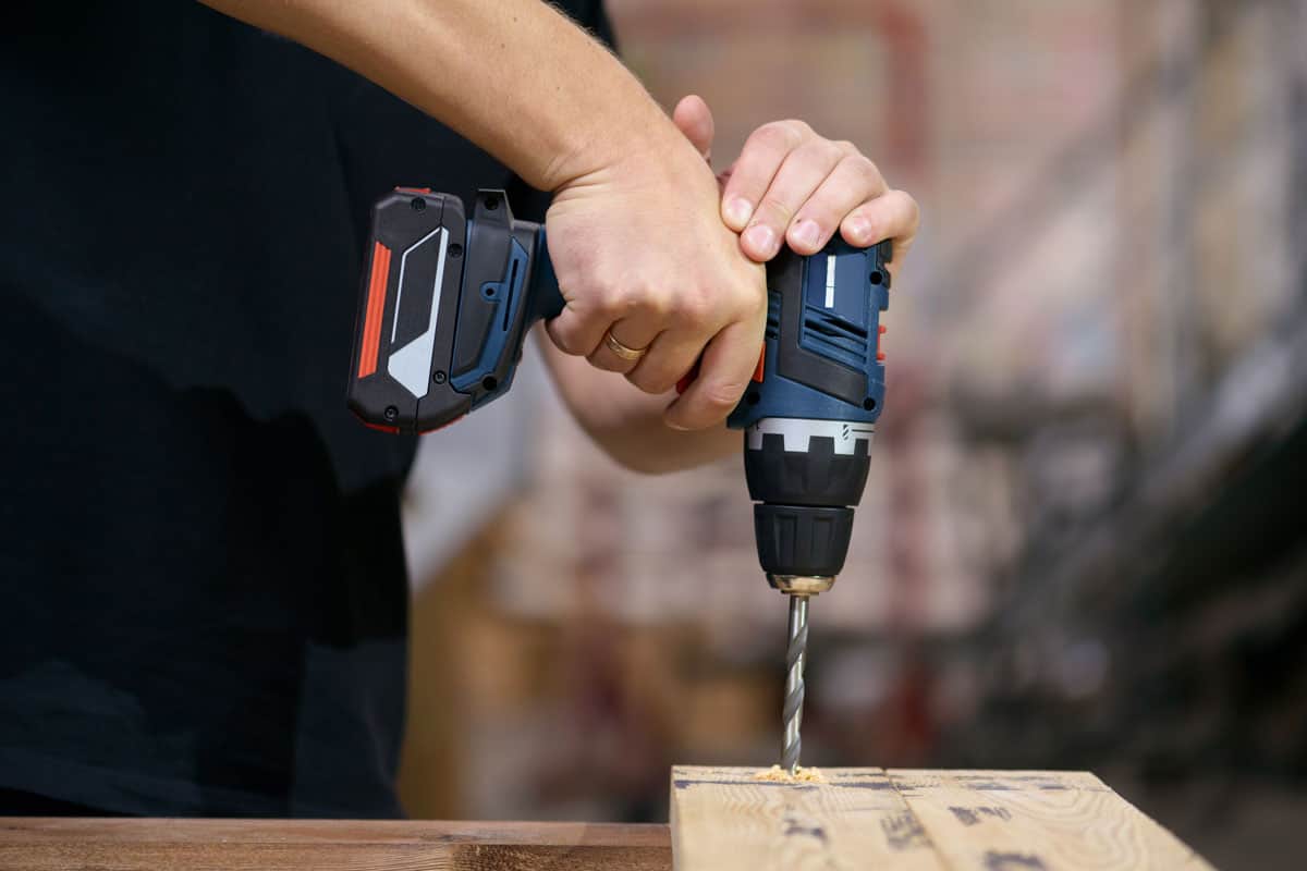 drilling wood plank with a battery drill