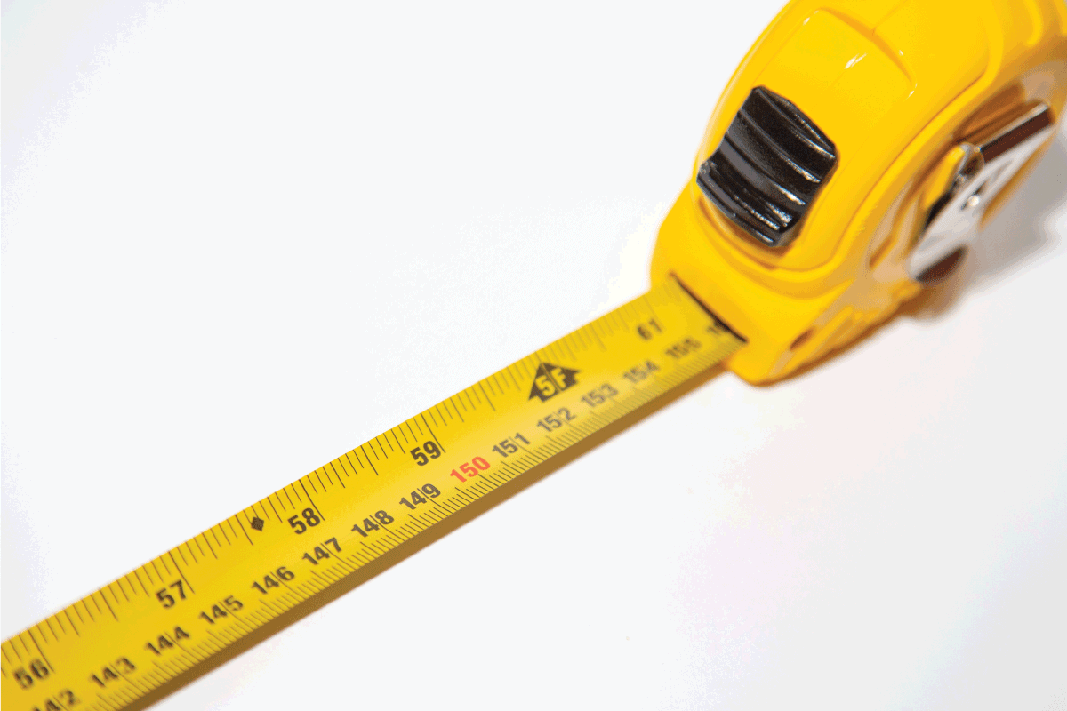 yellow measuring tape spread on a white tabletop 