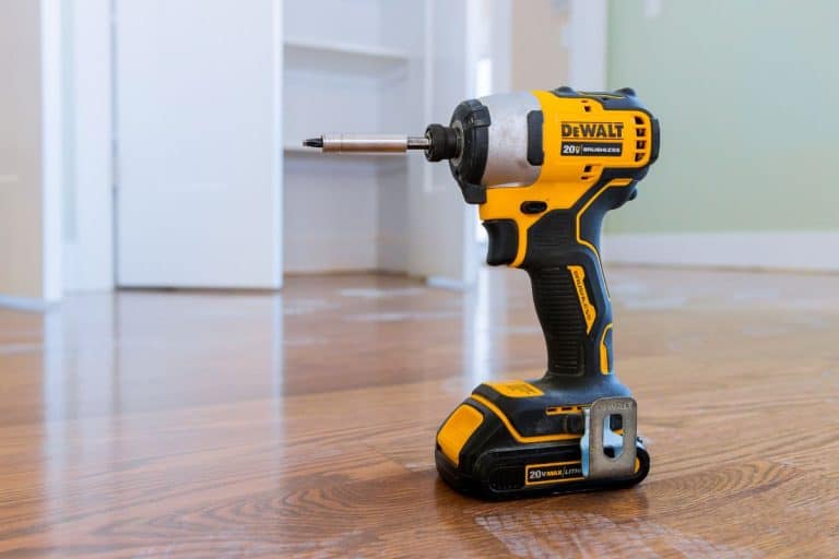 Modern cordless screwdriver, DeWalt drill with drill a wooden floor of new house for the construction. - How To Put A Dewalt Drill Back In The Case