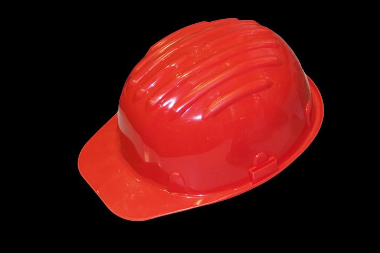 Red helmet on a black background, How To Put A Milwaukee Light On A Hard Hat