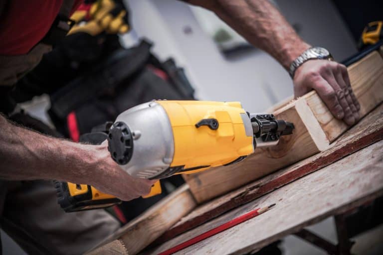 Woodwork Using Nail Gun. Caucasian Construction Worker Creating Wood Elements Using Powerful Nail Gun Tool. - How To Load A Dewalt Nail Gun [Quickly & Easily]