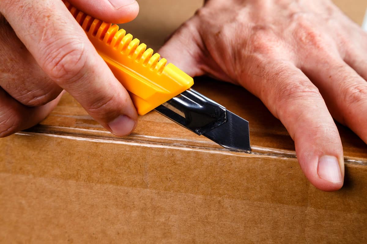 unboxing a box using a utility knife