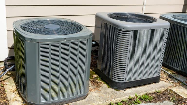 Home air conditioning units installed outside residential home, Who Makes AC Pro Air Conditioners: Your Guide to Finding the Manufacturer 1600x900