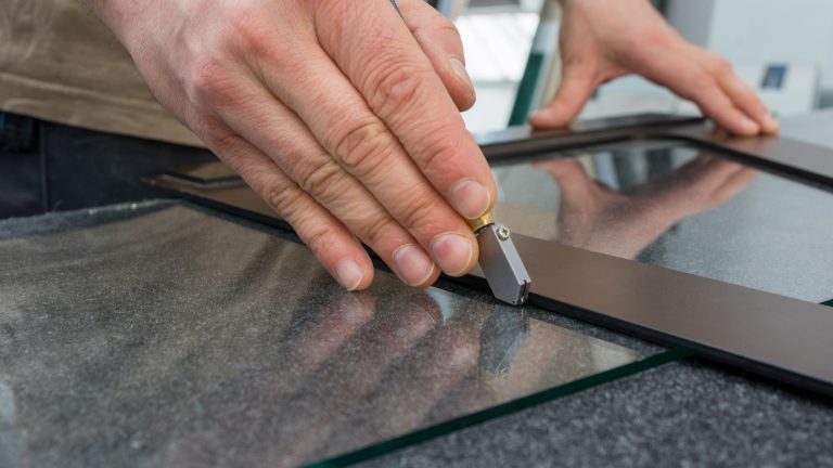 The glazier cuts the glass with a manual cutter, How to Master the Kobalt Glass Cutter [A Step-by-Step Guide]
